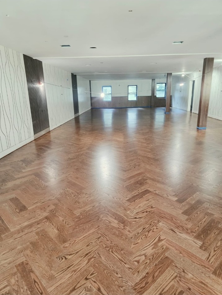 A finished hardwood floor with a detailed herringbone pattern